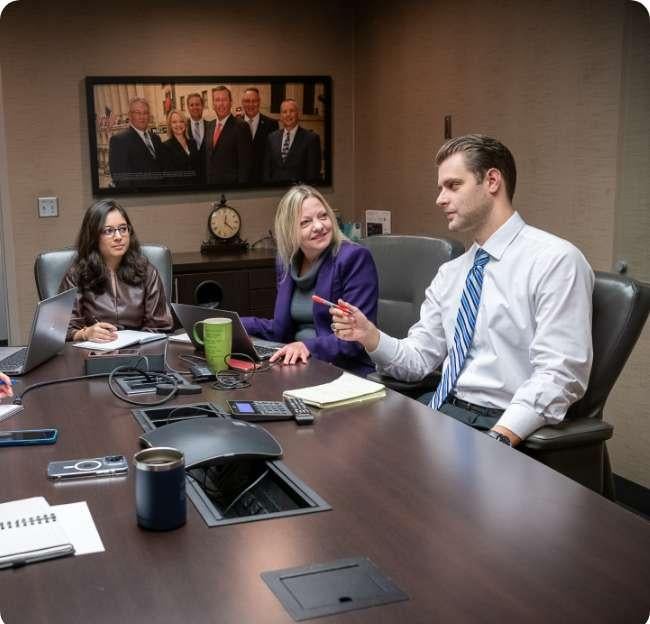 employees talking at conference room table