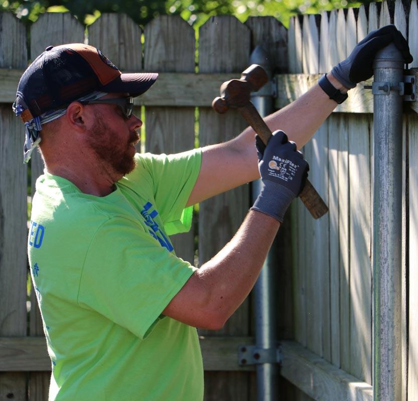 Man working on fence