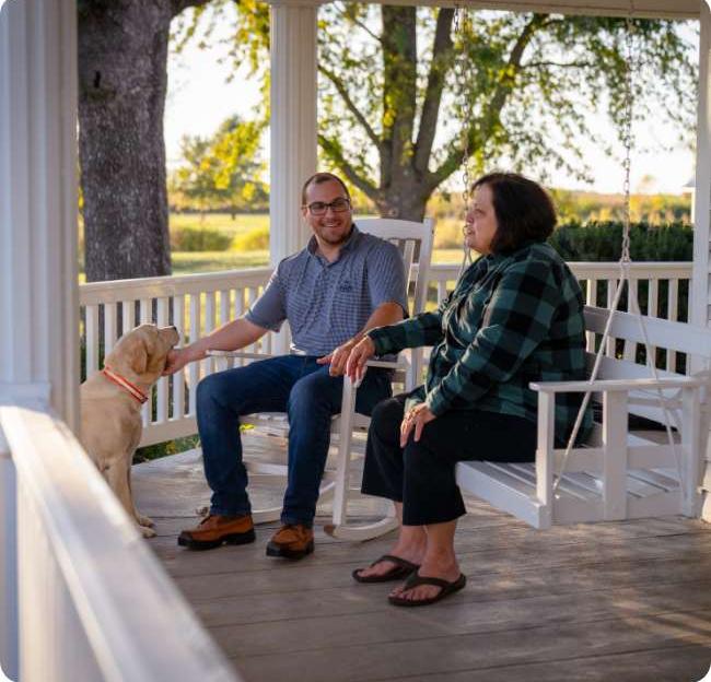 couple on porch with dog