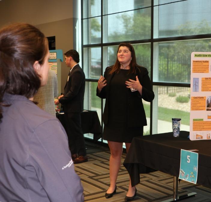 lady presenting at vendor booth in conference